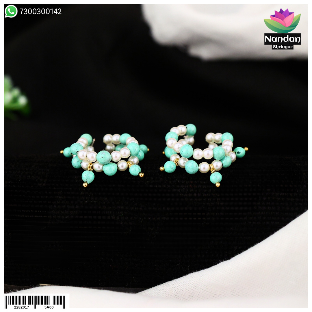 Nupur Firoja earrings by Nandanshringars featuring intricate gold-toned jewelry with traditional design.