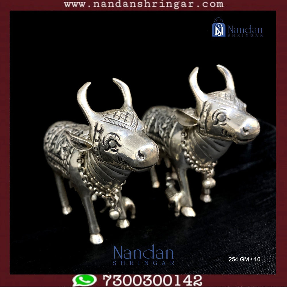 Fine silver cow figurines from Utsav Arts, featuring intricate detailing and a polished finish.