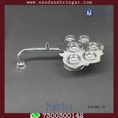 Fine silver Aarti by Utsav Arts, featuring intricate design and craftsmanship, displayed in elegant lighting.