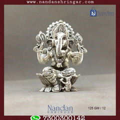 Fine silver Shree Ganesh idol by Utsav Arts, showcasing intricate detailing and traditional design elements.