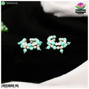 Nupur Firoja earrings by Nandanshringars featuring intricate gold-toned jewelry with traditional design.
