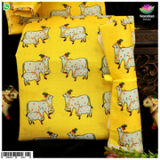 Yellow cow print vastra by Nandanshringars, featuring traditional fabric with cow motif and vibrant yellow color.