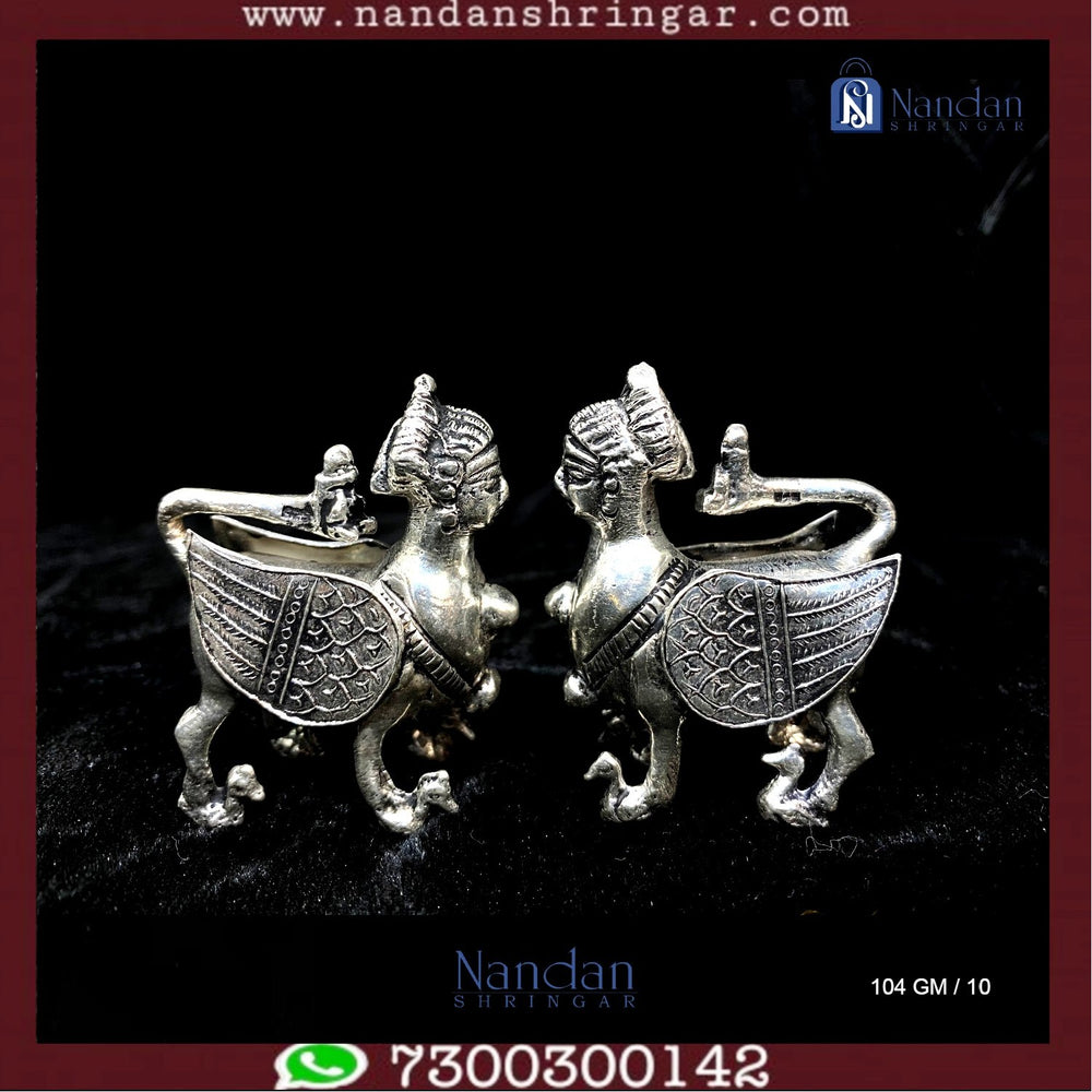 Fine silver Kaamdhenu cow figurines, beautifully crafted, showcasing intricate details from Utsav Arts.
