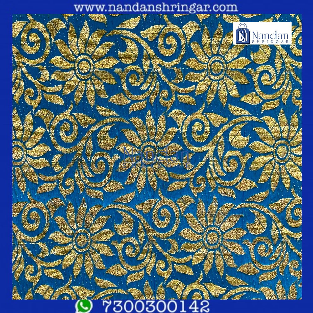 Dark blue designer Zari Vastra by nandanshringars, showcasing intricate patterns and luxurious fabric draping elegantly.