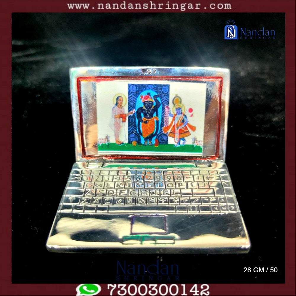 Fine silver laptop by Utsav Arts showcasing a sleek design and elegant finish.