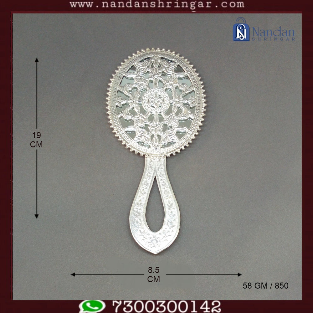 Fine silver Aarsi mirror by Utsav Arts, featuring intricate detailing and a reflective surface, displayed on a decorative stand.