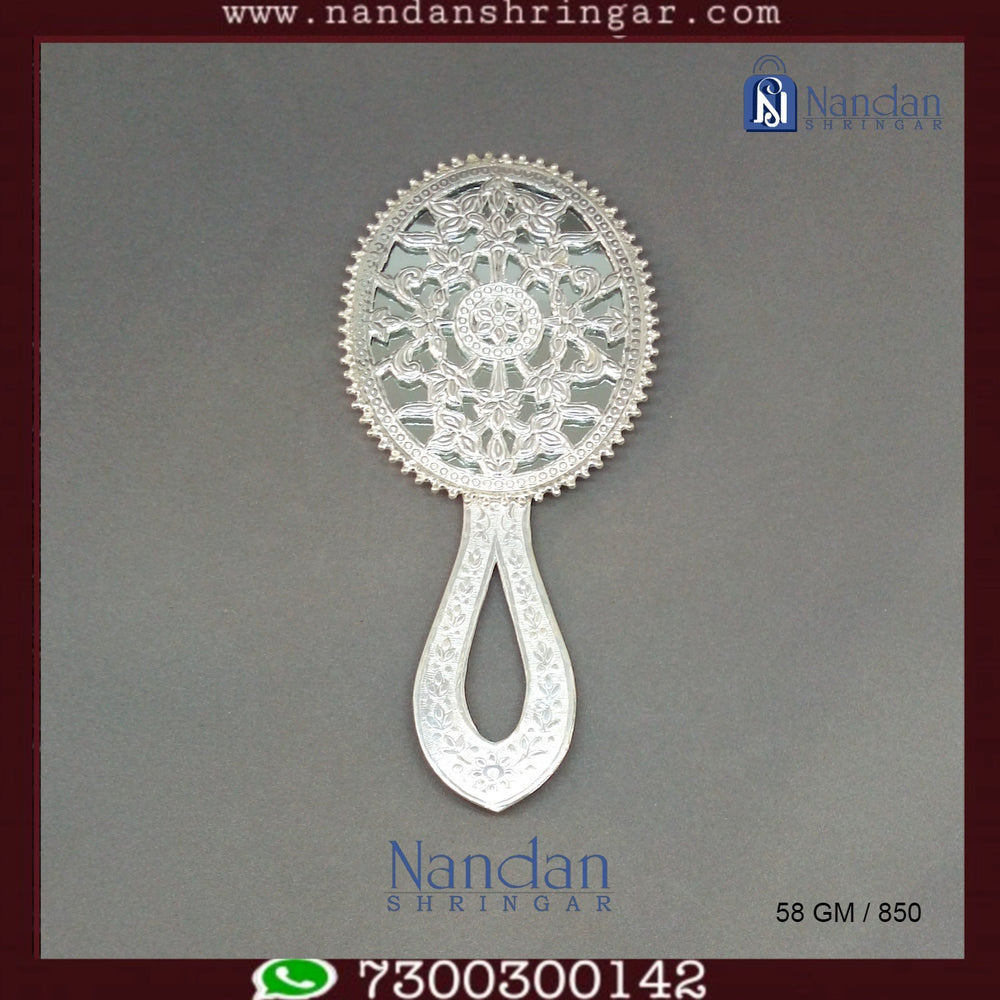 Fine silver Aarsi mirror by Utsav Arts, featuring intricate design and ornate detailing, displayed against a neutral backdrop.