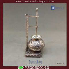 Fine silver carving Bilona set by Utsav Arts featuring intricate designs and elegant craftsmanship displayed on a soft background.