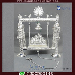 Premium fine silver carving palna by Utsav Arts, showcasing intricate designs and craftsmanship in a beautiful display.