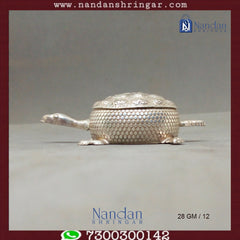 Fine silver tortoise sculpture by Utsav Arts, showcasing intricate detailing and craftsmanship in a decorative design.