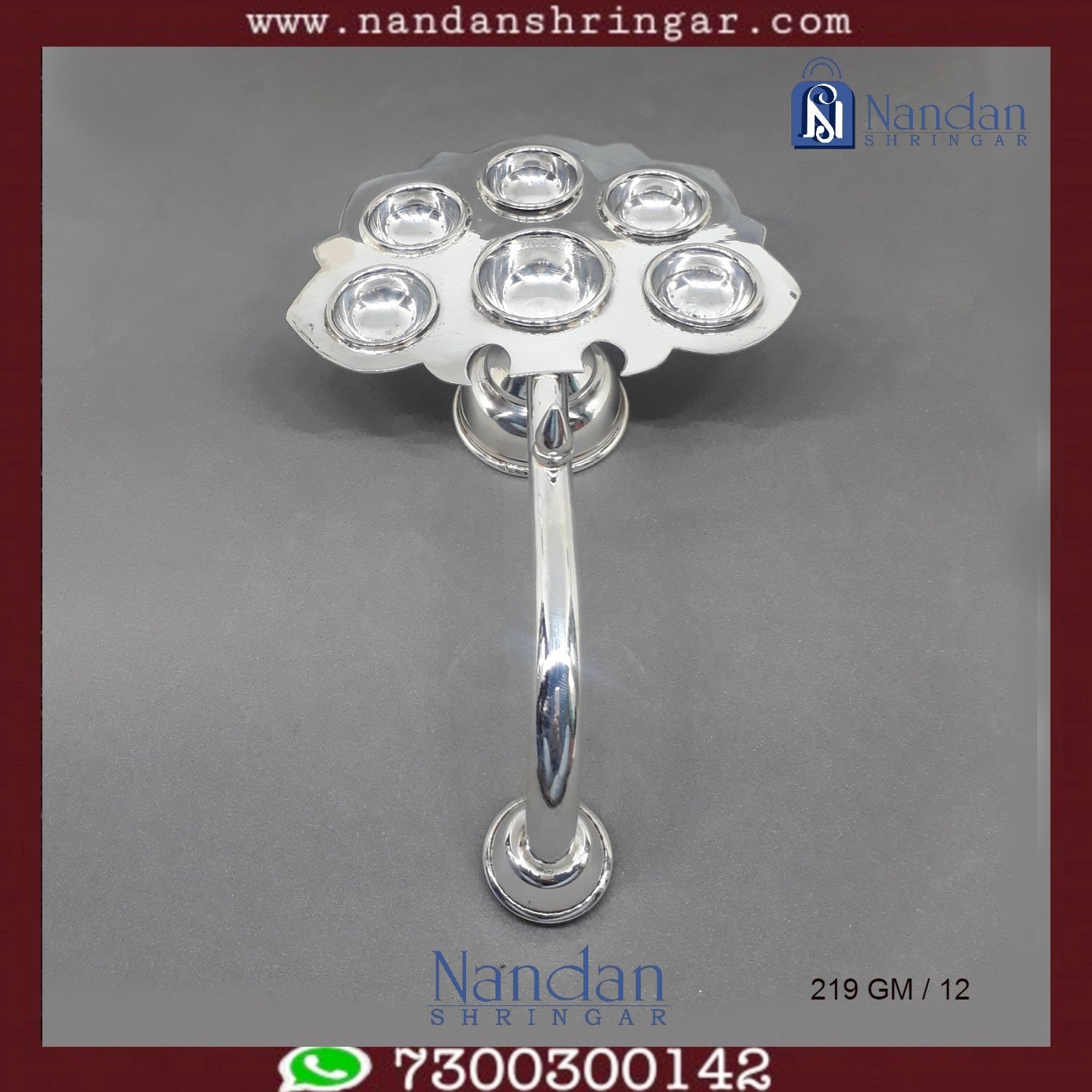 Fine silver Aarti by Utsav Arts, showcasing intricate detailing and traditional design in a beautifully crafted piece.