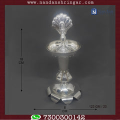 Fine silver Mayur fountain by Utsav Arts, showcasing intricate design and elegant craftsmanship in a decorative setting.