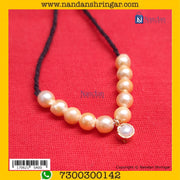 Real pearl Moti Mala by Nandanshringars featuring traditional design and lustrous white pearls on a delicate string.