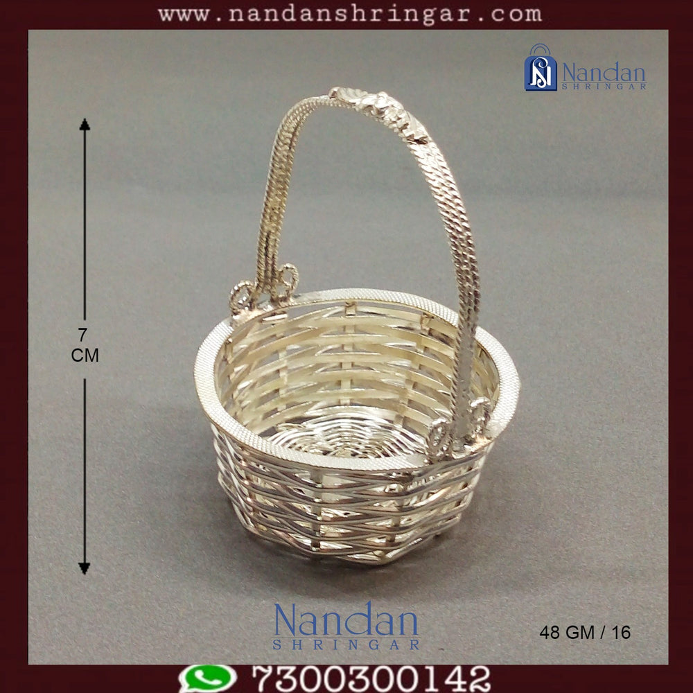 Fine silver basket by Utsav Arts featuring intricate design and craftsmanship, showcasing elegant curved handles and smooth finish.